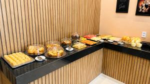 a buffet line with many different types of food at River Suites Hotel Barreirinhas in Barreirinhas