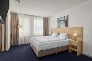 a hotel room with a bed and a window at Riverside Hotel Merian - opening 2026 in Basel +70 photos
