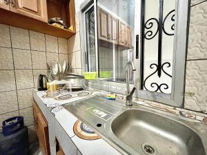 a kitchen with a sink and a counter at Résidence T&M ODZA Yaoundé Cameroun in Méhandan +15 photos