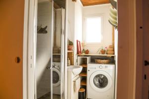 a laundry room with a washer and dryer at Guesthouse Évasion in Contis-les-Bains +18 photos