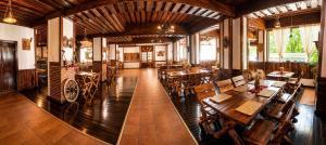 a large room with tables and chairs in a restaurant at Terasa Baniei in Bucovăţ