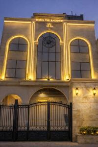 a building with a clock on the front of it at Hotel The Raghavas' in Ayodhya