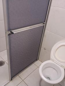 a bathroom with a toilet with a sliding door at Marins Pousada - Campos do Jordão in Campos do Jordão +82 photos