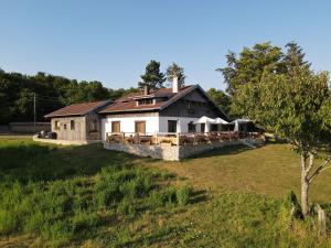 a house on a grassy field with a building at Le chalet des Etoiles in Lavans-Vuillafans