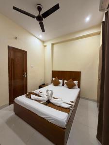 a bedroom with a bed with a ceiling fan at Kashi Vilas in Varanasi