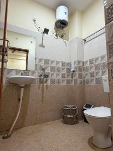 a bathroom with a toilet and a sink and a mirror at Kashi Vilas in Varanasi +20 photos