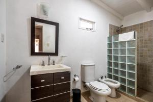 a bathroom with a toilet and a sink and a mirror at Casa Campo Hotel Boutique - San Pedro in San Pedro +22 photos