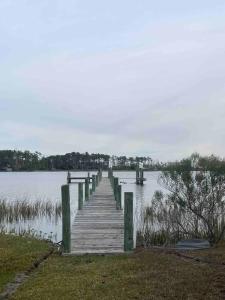 a wooden dock in the middle of a lake at Waterfront Home 3BR King bed Private Dock in Smyrna