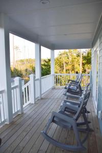 three lounge chairs sitting on the porch of a house at Waterfront Home 3BR King bed Private Dock in Smyrna