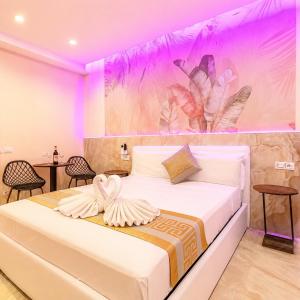 a bedroom with a large bed with pink lighting at Bed Cinecittadue in Rome