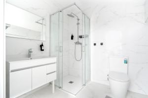 a white bathroom with a shower and a toilet at AL Hirondelle in Sernancelhe +25 photos