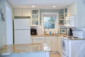 a kitchen with white appliances and a white refrigerator at Steps to Beach 2BR 2BA duplex in Atlantic Beach