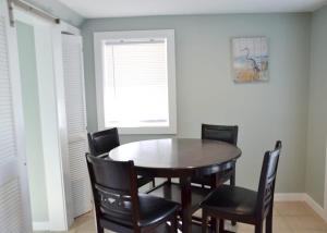 a dining room with a wooden table and chairs at Steps to Beach 2BR 2BA duplex in Atlantic Beach