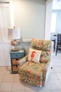 a room with a chair with a pillow and a table at Steps to Beach 2BR 2BA duplex in Atlantic Beach