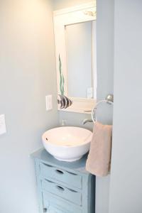 a bathroom with a sink and a mirror at Steps to Beach 2BR 2BA duplex in Atlantic Beach +8 photos