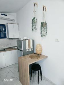 a kitchen with a small table and a refrigerator at Cozy Family Studio 2 in Ksamil