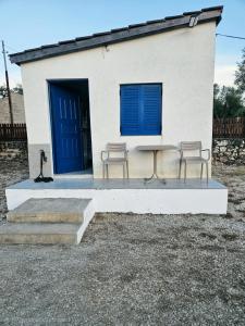 a table and two chairs in front of a building at Cozy Family Studio 2 in Ksamil