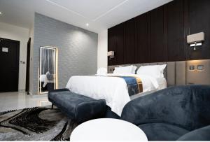 a hotel room with a bed and a couch at Oxvera Hotel Limited in Umuahia