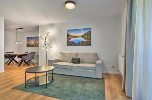 a living room with a couch and a table at Annies Bergwelt Haus Waldliebe in Bodenmais