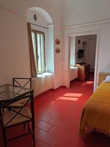 a bedroom with a bed and a red tile floor at Dimora San Pietro in Ferrandina