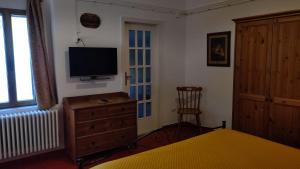 a bedroom with a bed and a television on a dresser at Dimora San Pietro in Ferrandina