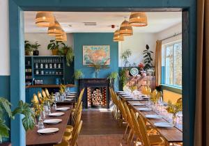 a long table in a room with blue walls at The Common Knowledge Centre in Kilfenora