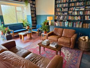 a living room with a couch and a table at The Common Knowledge Centre in Kilfenora