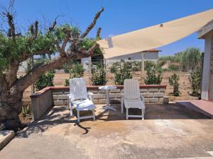 two chairs and a table on a patio at Villa Aurora in Ispica