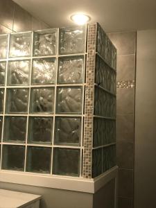 a wall of glass panels in a bathroom at Oceanfront Townhouse steps to the Beach in Atlantic Beach +12 photos