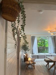 a living room with a chair and a table at Private Rock Onsen Villa Orin & Zen Garden in Shiraoi