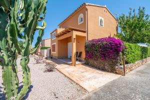 a house with a cactus in front of it at Villas2meet La Siesta in Cala Romàntica