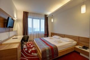 Postel nebo postele na pokoji v ubytování Hotel Ave Lux