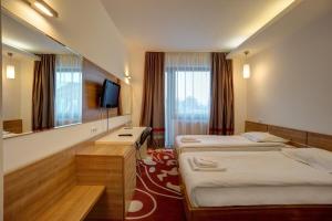 Postel nebo postele na pokoji v ubytování Hotel Ave Lux