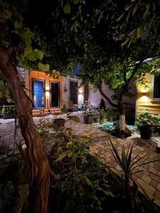 a courtyard at night with trees and plants at Dream House in Yerevan
