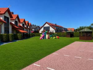 a yard with a playground and some houses at Koja in Rowy