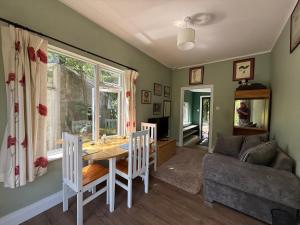 a living room with a table and a couch at Shannon River House & Gardens in Limerick