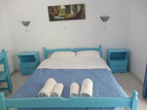 a bedroom with a blue bed with two blue tables at Iliotropio Ligia in Ligia