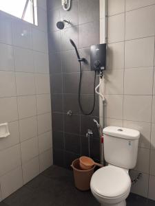 a bathroom with a shower with a toilet in it at klebang Beachfront Homestay I Snooker I Massage Chair I Pool in Malacca +16 photos