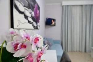 a vase with pink flowers in a living room at Pepe'Accommodation in Parghelia