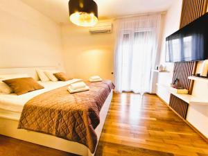 a hotel room with a bed and a television at Rooms Hana Rovinj in Rovinj