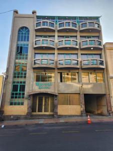 a tall building with a sign on the front of it at Hotel Marsal in Antofagasta