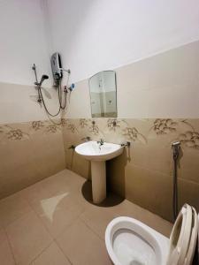 a bathroom with a sink and a toilet at Panda House in Galle