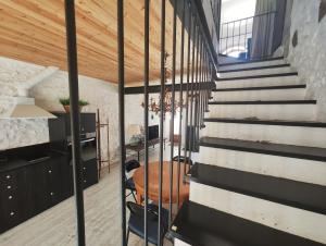 a staircase in a house with a table and chairs at Els Sifons in Castelltersol
