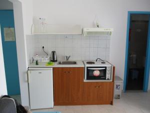 a small kitchen with a sink and a stove at Iliotropio Ligia in Ligia +28 photos