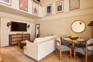 a living room with a couch and a table at Faraway Sag Harbor in Sag Harbor