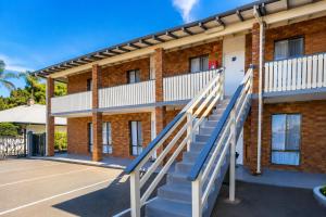 a staircase leading up to a brick building at Busselton Motel in Busselton