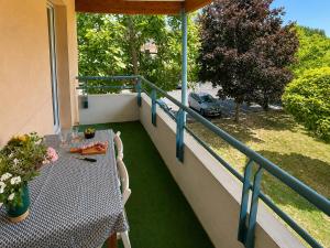 a table and chairs on a balcony with a view at " Balcon Nature " Terrasse - TV - Fibre in Muret