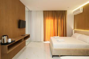 a hotel room with a bed and a television at LiEl Holiday in Vlorë
