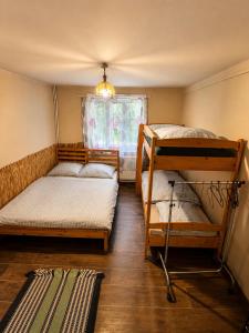 a room with two bunk beds and a window at Basecamproll in Pec pod Snezkou