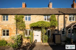 an old brick house with a white door at Charlotte's Cottage, a Charming Cotswolds Getaway in Adlestrop +11 photos